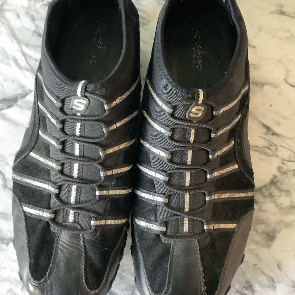 Women’s size 11M Skechers pull on  black & silver metallic rubber sole shoes